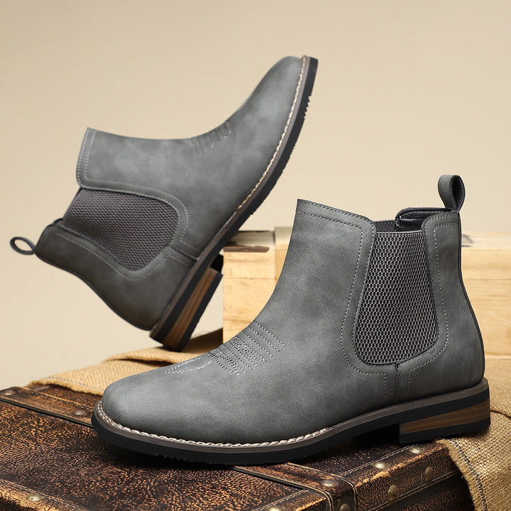 Stylish men's gray Chelsea ankle boots, perfect for casual yet elegant outfits, featuring a modern square toe.