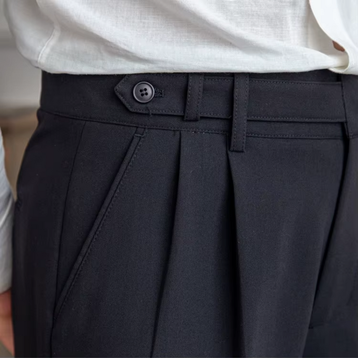 Black men's tailored pleated trousers, designed for an elegant and professional business look.
