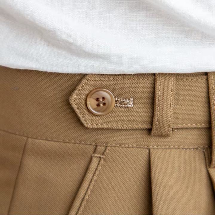 Men's pleated beige dress pants, tailored for comfort and classic business casual style.