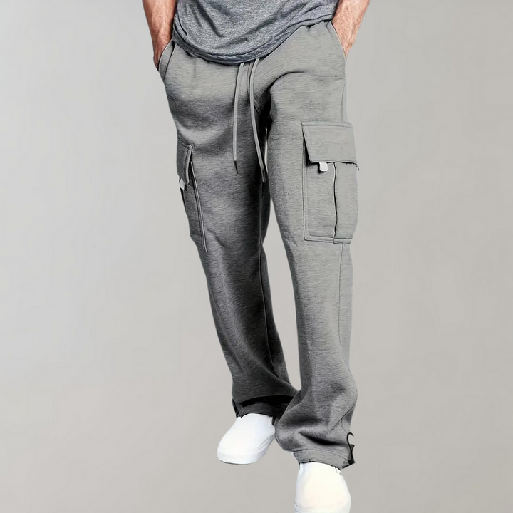 Close-up of the drawstring waist and cargo pocket on men's utility jogger pants in a grey fabric