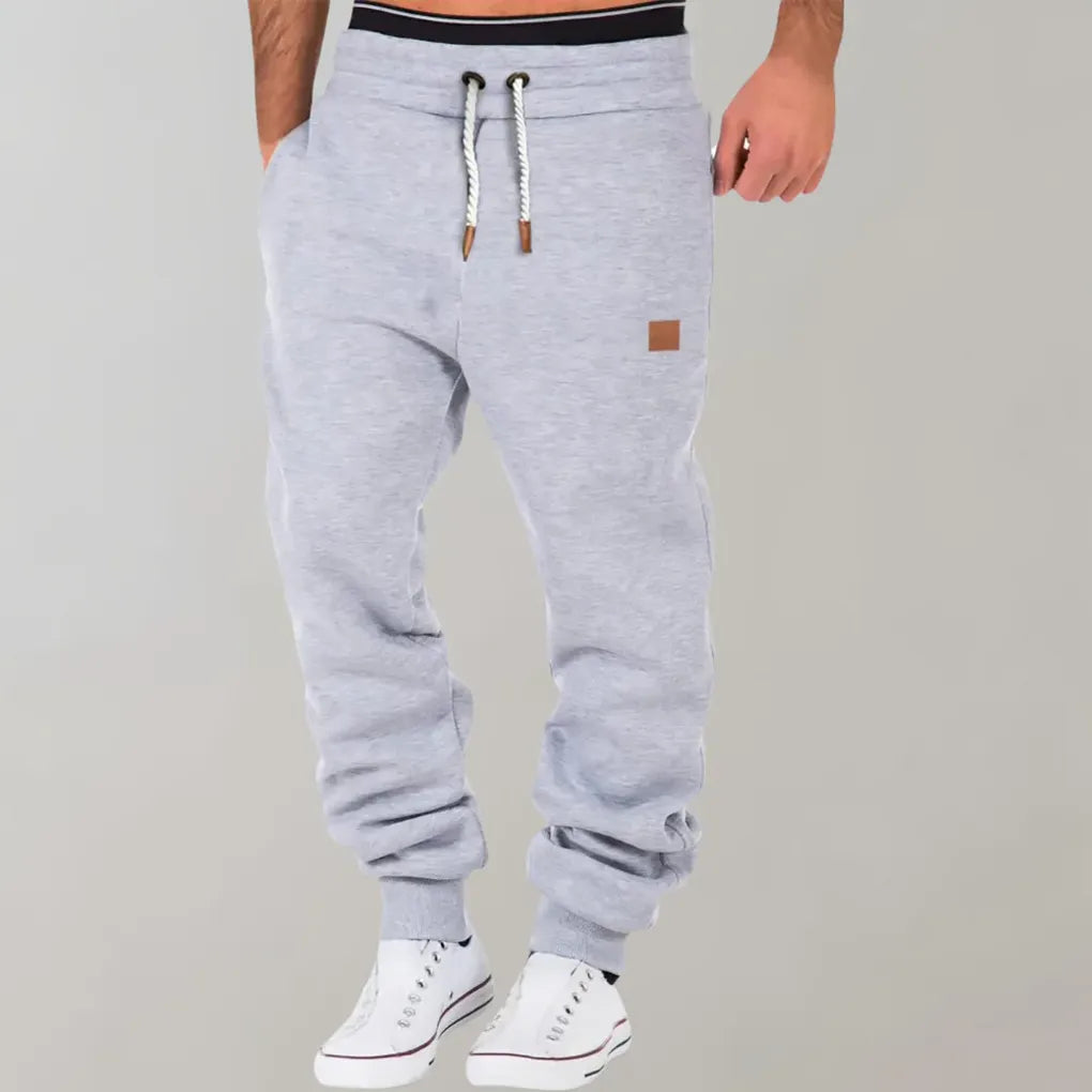 Casual men's athletic jogger pants in a cotton blend, featuring cuffed ankles and an adjustable drawstring.