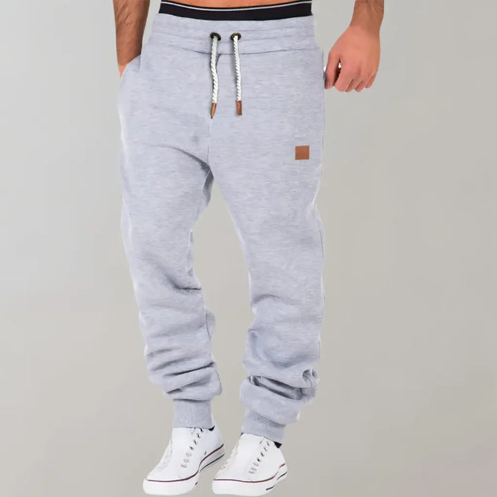 Casual men's athletic jogger pants in a cotton blend, featuring cuffed ankles and an adjustable drawstring.
