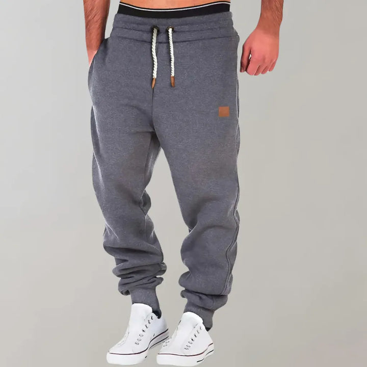 Close-up of men's cotton blend jogger pants showcasing the cuffed ankles and durable fabric.