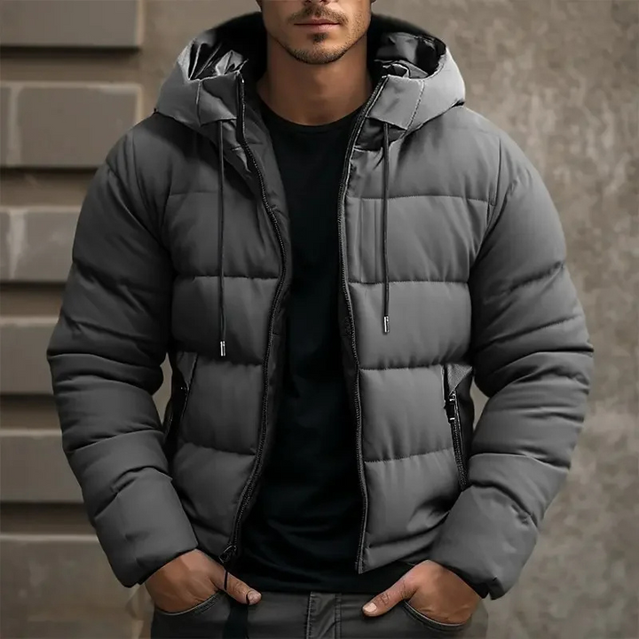 Modern men's quilted puffer jacket with hood. Casual winter outerwear for a stylish look.