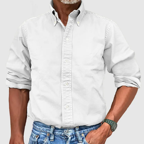 Man wearing a blue wrinkle-resistant long-sleeve casual shirt, showcasing its comfortable fit.