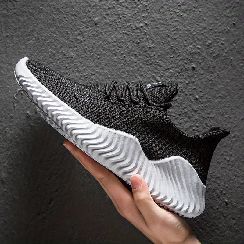 Stylish men's lace-up casual sneakers, offering lightweight comfort and a modern sculpted sole design.