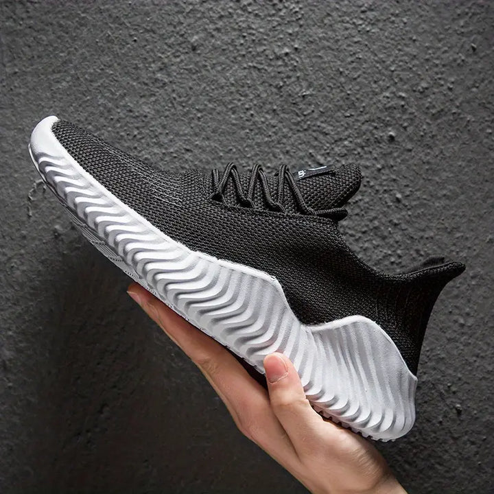 Stylish men's lace-up casual sneakers, offering lightweight comfort and a modern sculpted sole design.