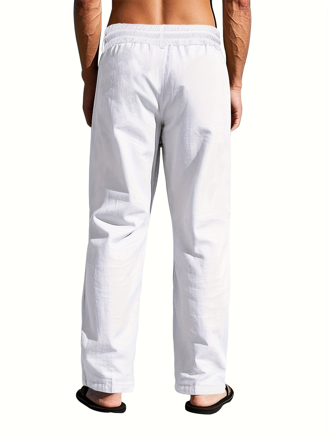Folded light-colored men's linen pants with a drawstring, highlighting their lightweight design.