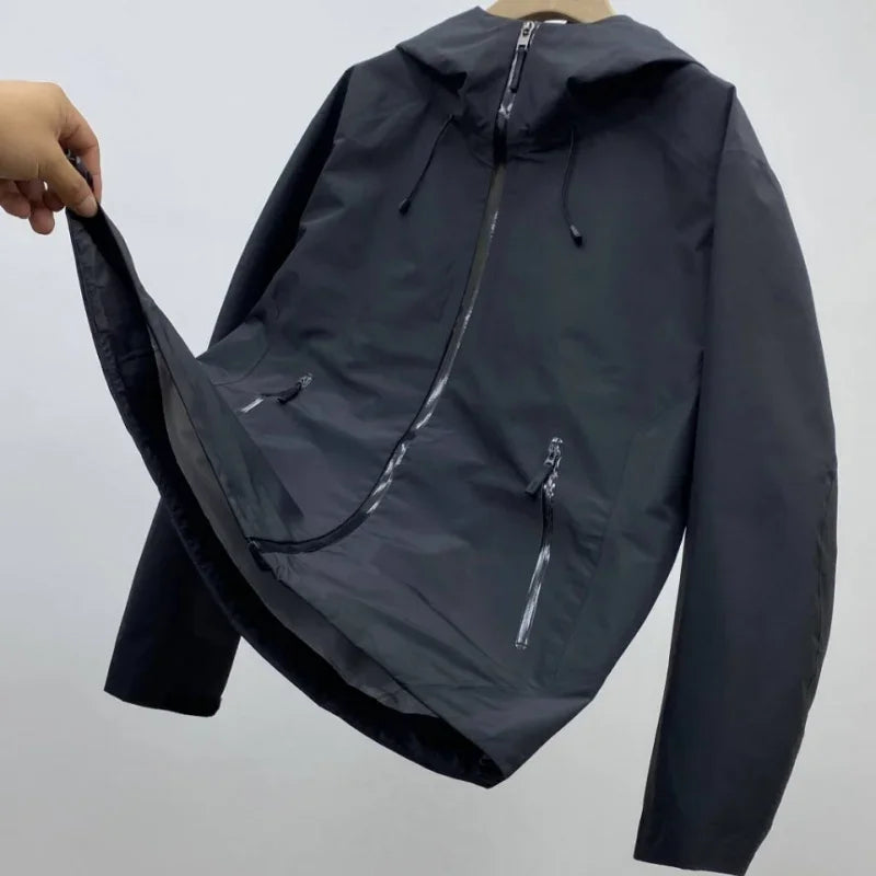 Back view of a men's waterproof shell jacket, showcasing its clean design for active outdoor adventures.