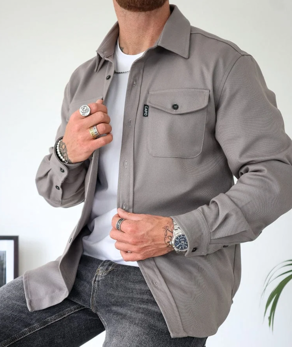 Stylish men's long sleeve button-down shirt, versatile design, close-up of pocket detail