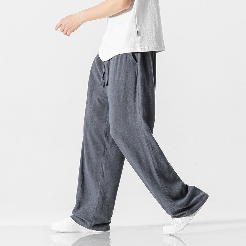 Full-length men's casual pants, featuring a loose fit design & adjustable drawstring waist for ultimate comfort.