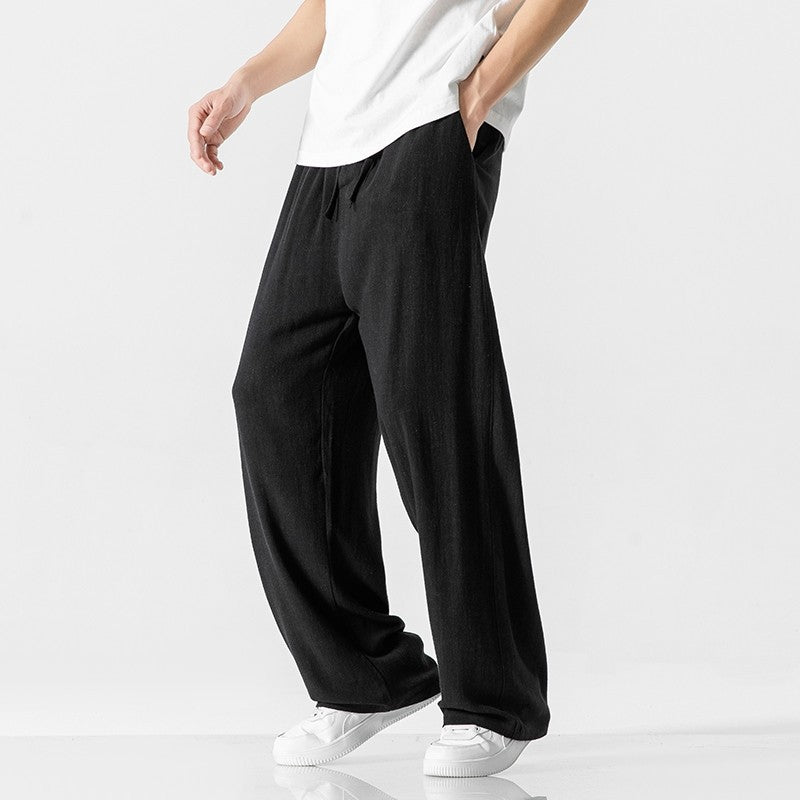 Comfortable men's loose fit pants, ideal for daily wear with an elastic drawstring waist for freedom of movement.