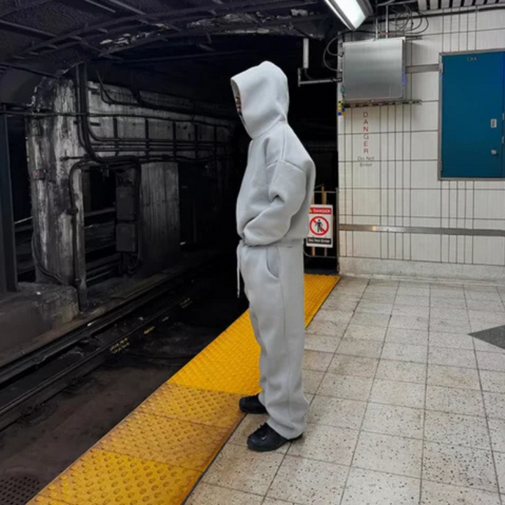 Stylish men's tracksuit, a minimalist hooded sweater and matching pants in navy