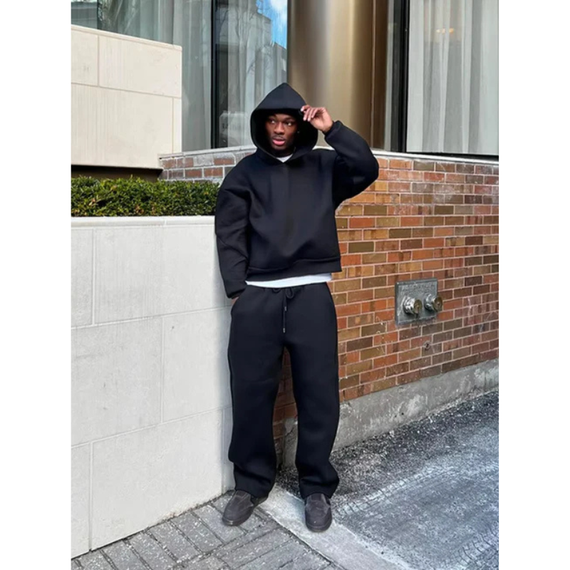 Cozy men's outfit featuring a hooded sweater and tracksuit bottoms for ultimate comfort
