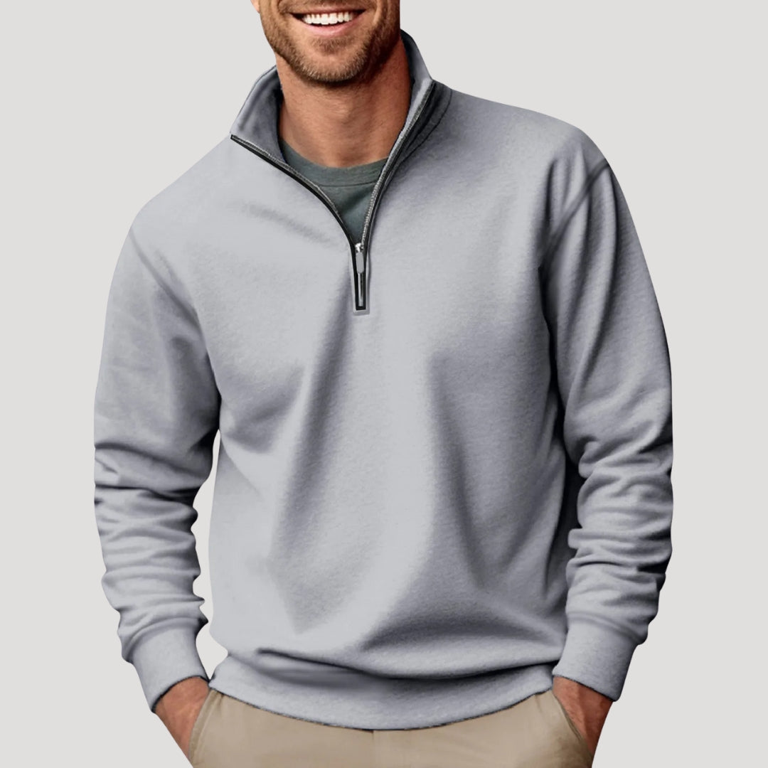 Model wearing a men's comfortable black quarter zip long sleeve sweatshirt, ideal for layering