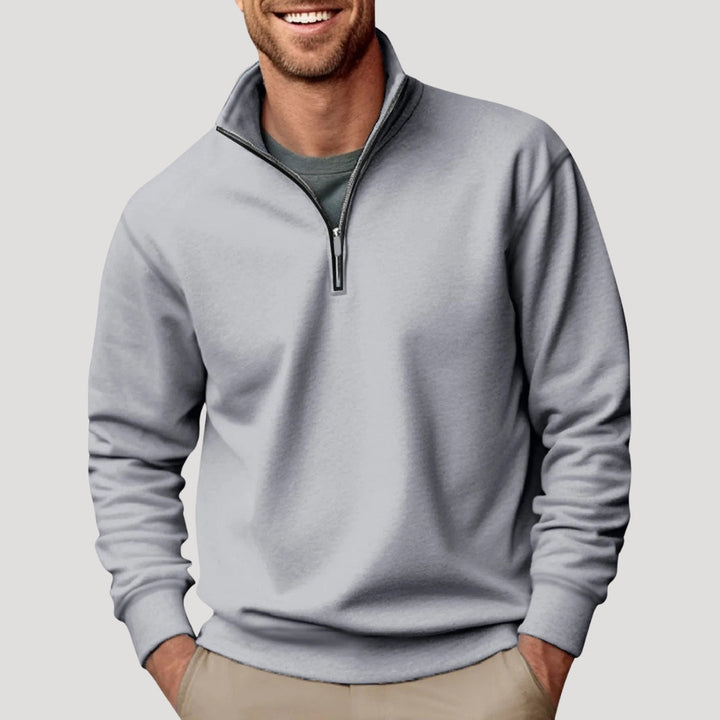 Model wearing a men's comfortable black quarter zip long sleeve sweatshirt, ideal for layering