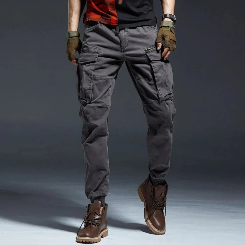 Gray men's cargo pants, durable & comfortable for hiking, travel, or everyday casual style.