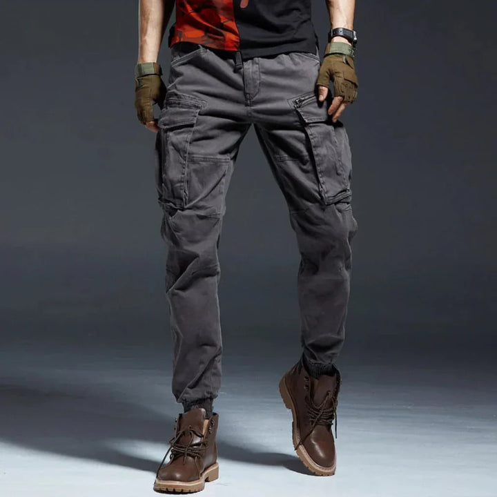 Gray men's cargo pants, durable & comfortable for hiking, travel, or everyday casual style.
