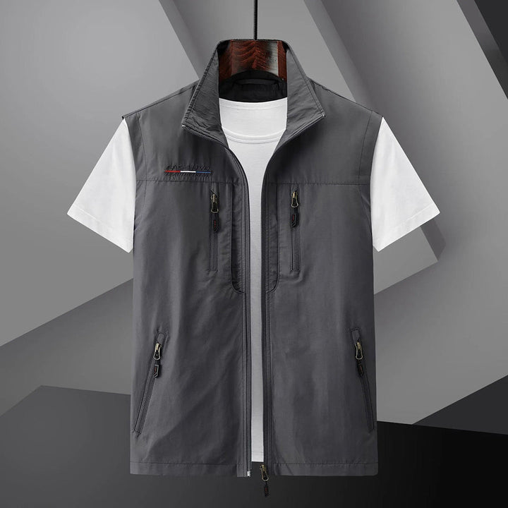 Lightweight multi-pocket men's safari utility vest for summer, breathable and durable outdoor gear.
