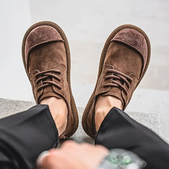 Close-up of men's orthopedic khaki leather shoes, highlighting texture and comfort features.