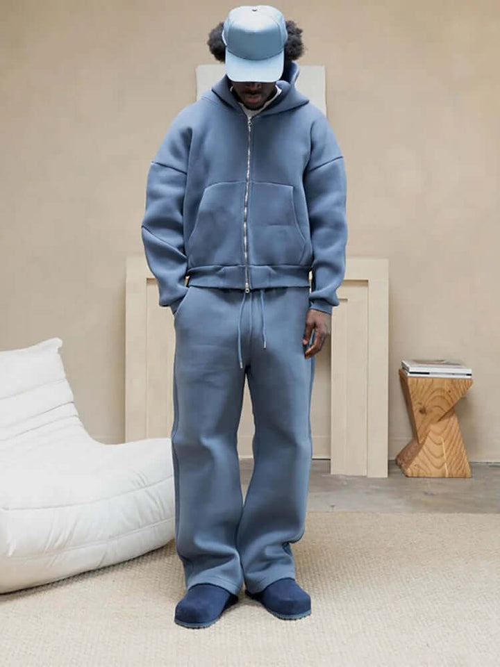Men's oversized grey tracksuit set, casual hoodie & straight leg pants for comfortable loungewear.