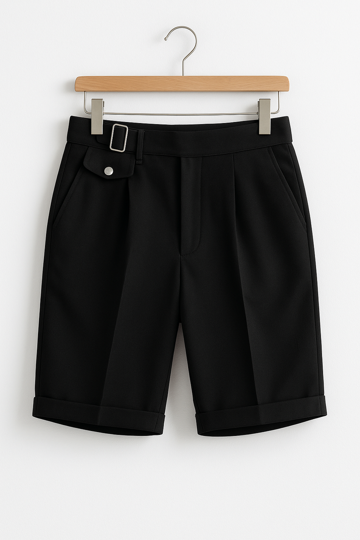 Front view of men's tailored shorts featuring pleats and adjustable side buckles for comfort.