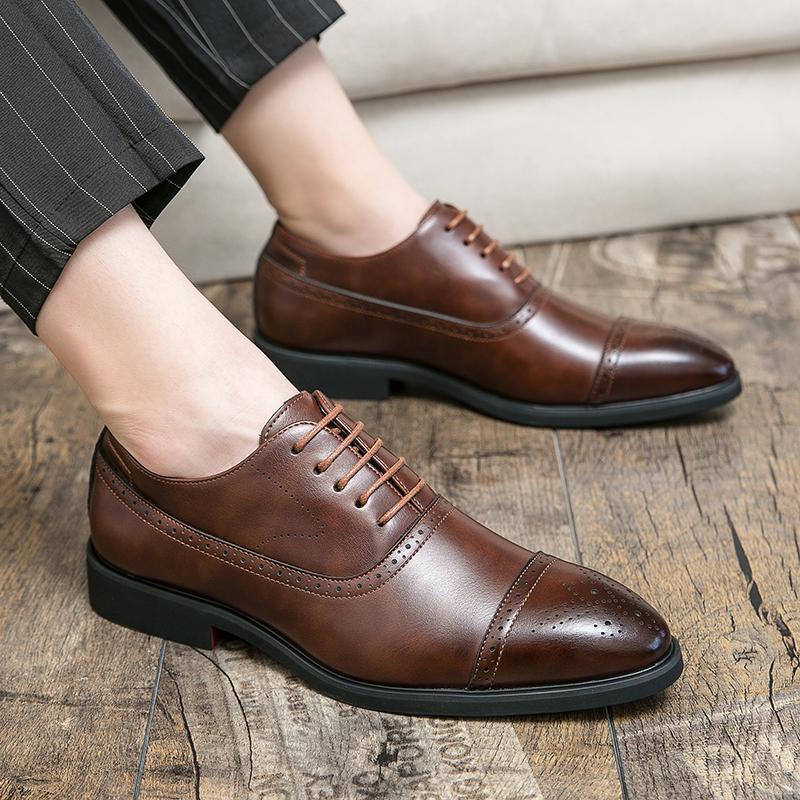 Men's polished black leather brogue oxford dress shoes, ideal for formal wear, business meetings & elegant occasions.