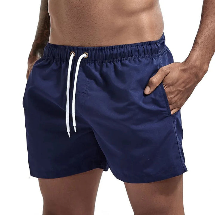Model wearing Men's Quick-Dry Performance Swim Shorts, demonstrating comfort for beach & sport