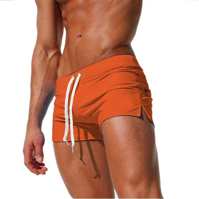 Man wearing quick-dry swim shorts, ready for beach activities; comfortable activewear for summer & pool.