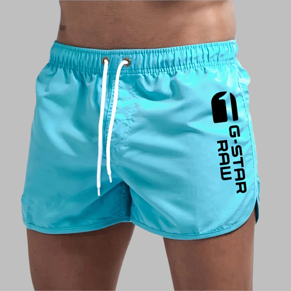 Men's quick-dry swim trunks, solid color, ideal for beach or poolside wear, available S-2XL.