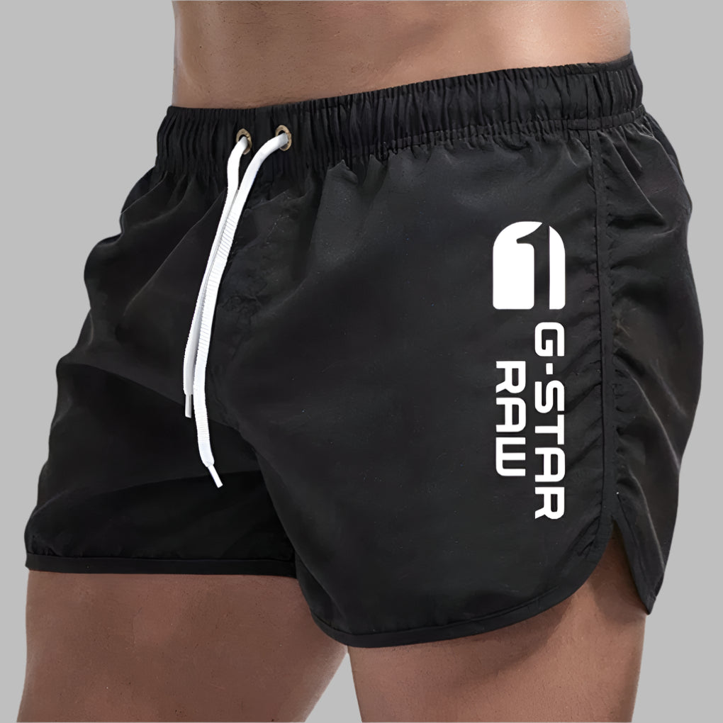 Athletic men's swim trunks, quick-dry fabric in a solid color, perfect for summer fashion.