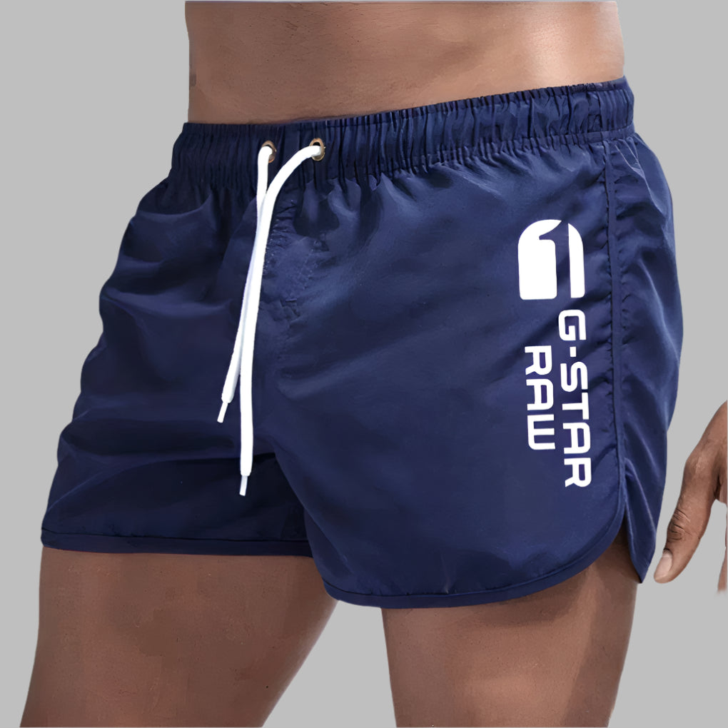 Solid color men's swimwear, quick-dry material, versatile for beach, pool, or athletic wear.
