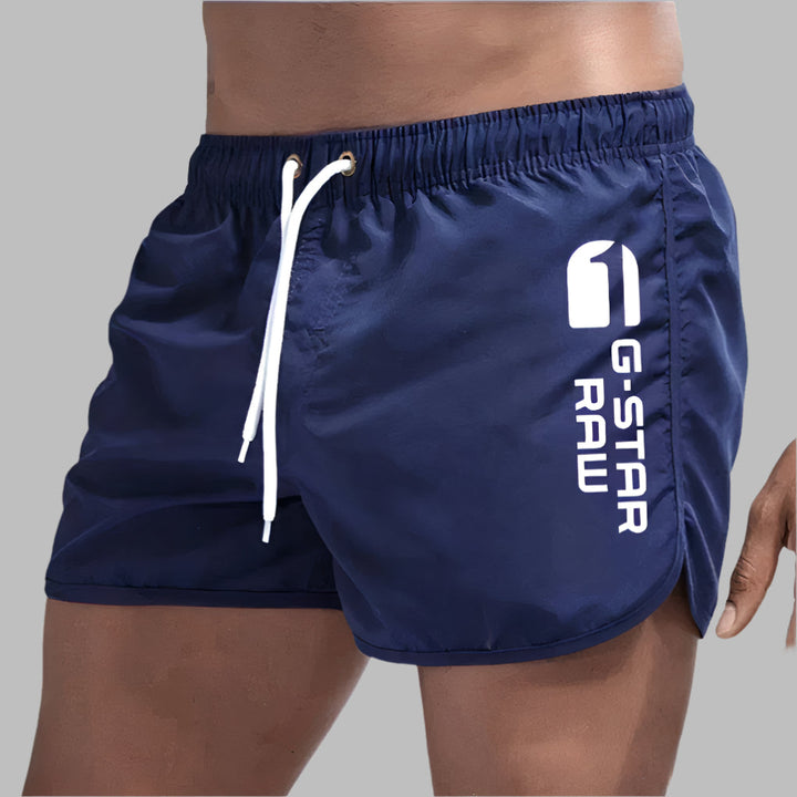 Solid color men's swimwear, quick-dry material, versatile for beach, pool, or athletic wear.