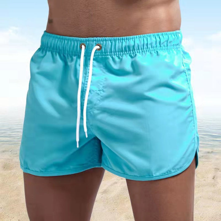 Fast-drying men's swim trunks, elastic waist & drawstring. Essential men's swimwear for beach and pool.