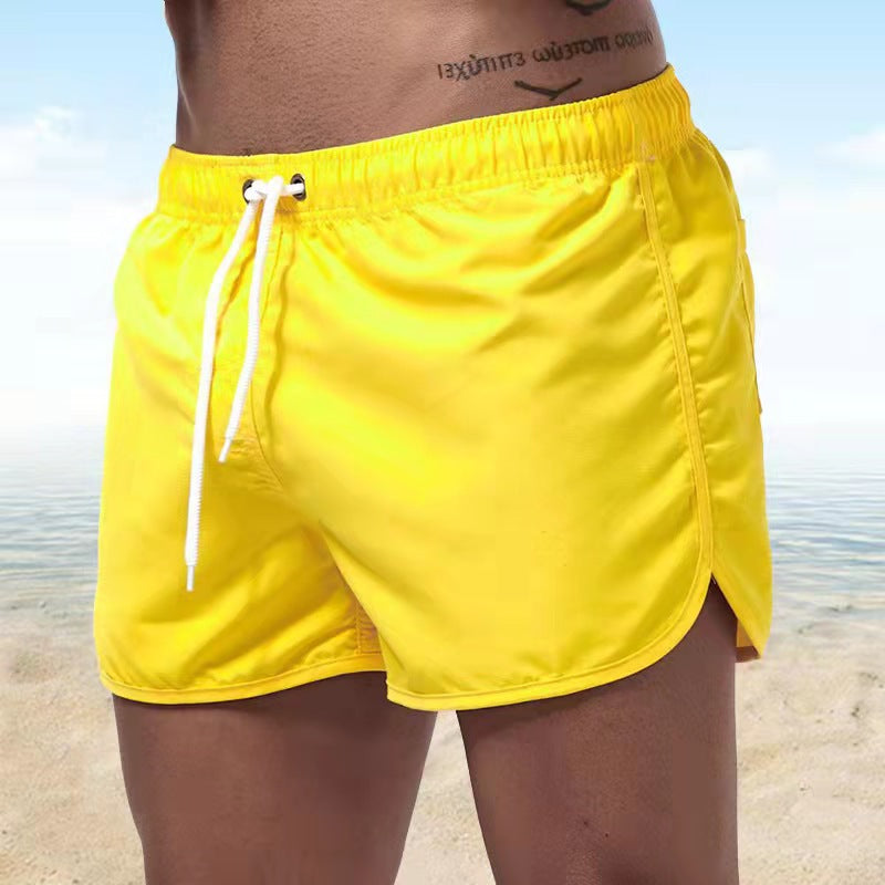 Versatile men's quick-dry swim trunks, functioning as beach shorts & activewear with elastic drawstring.