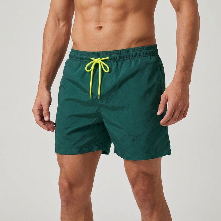 Men's quick-dry swimwear, adjustable waist, designed for comfort and style at the beach/pool.