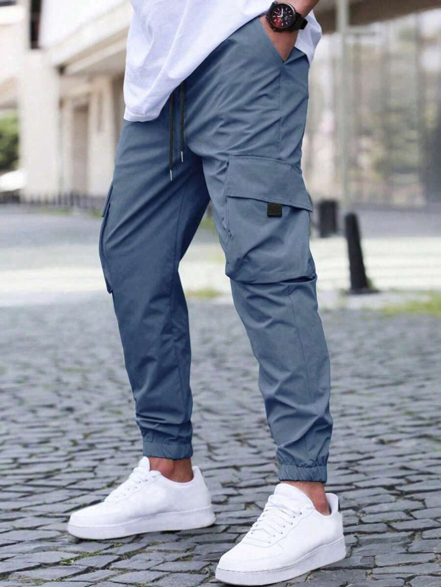 Close-up of utility pocket on men's casual cargo jogger pants fabric