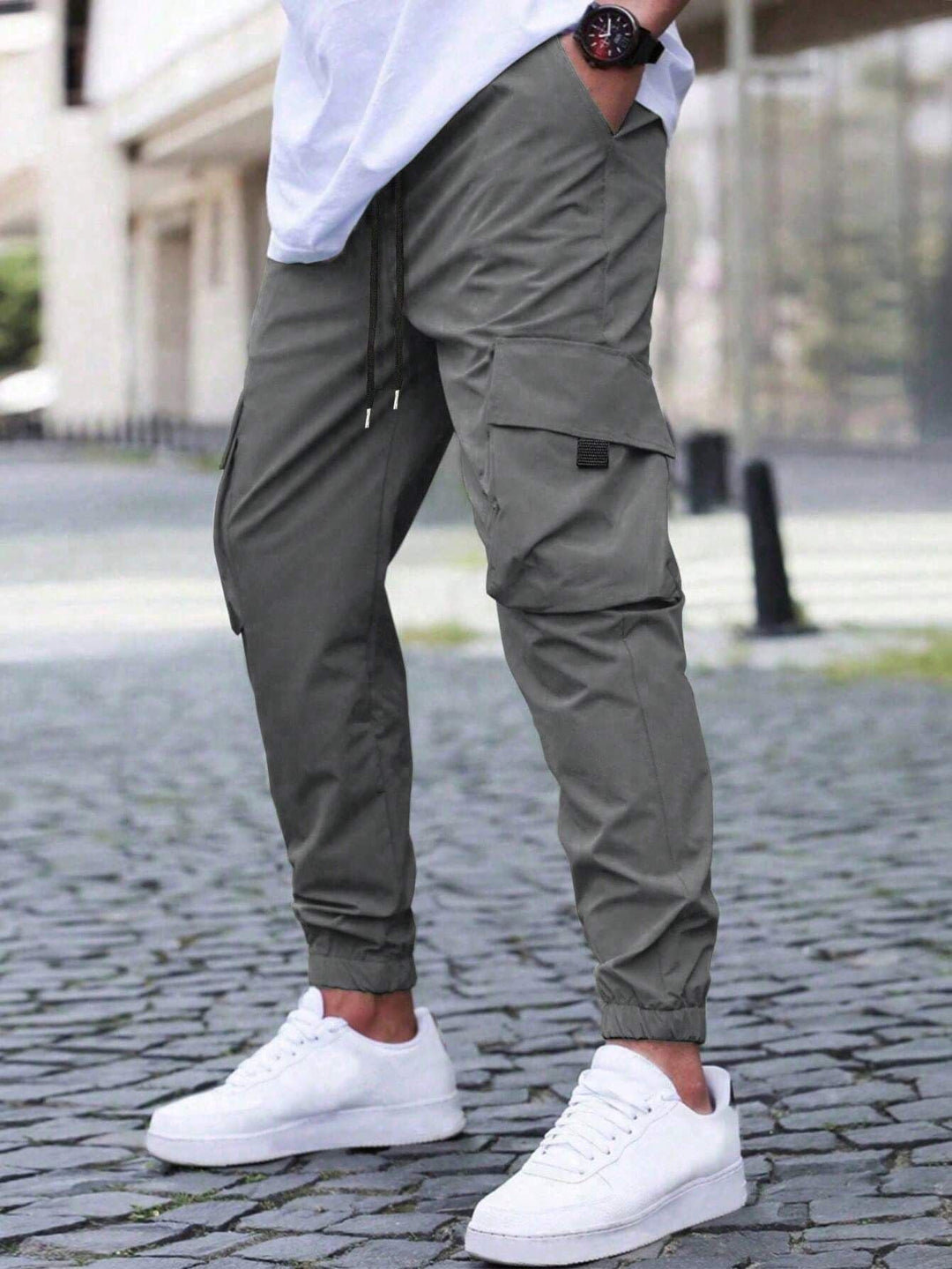 Folded men's relaxed fit utility cargo jogger pants, showcasing fabric and details