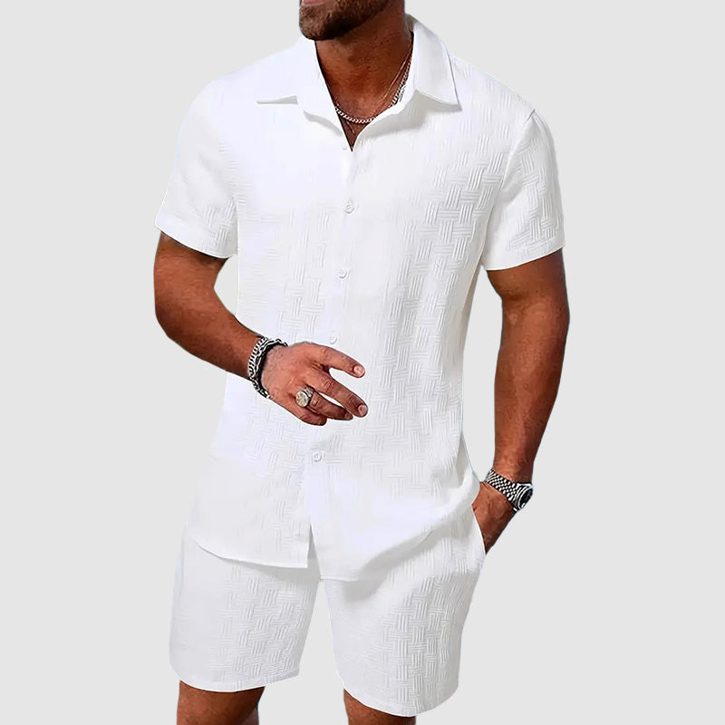 Casual men's two-piece set featuring a relaxed button-down collared shirt and matching shorts for summer.