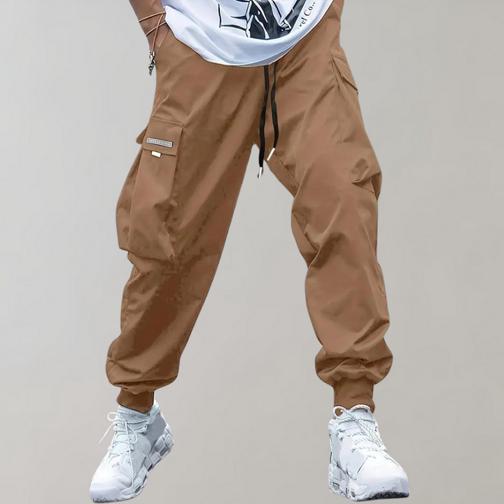 Comfortable men's relaxed fit cargo trousers featuring a flexible drawstring waist, perfect for everyday streetwear.