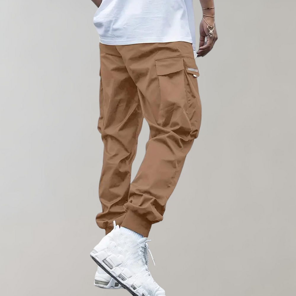 Men's relaxed fit cargo pants with practical utility pockets & drawstring waist, great for a casual streetwear look.