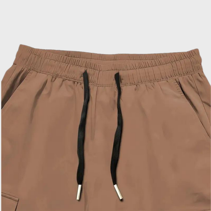 Durable men's relaxed fit cargo trousers, comfy drawstring waist, spacious pockets; versatile casual pants.
