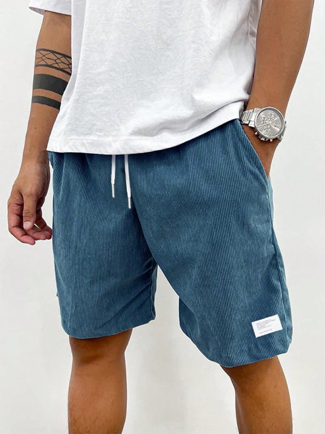 Detail shot of the adjustable drawstring waistband on men's relaxed fit shorts.