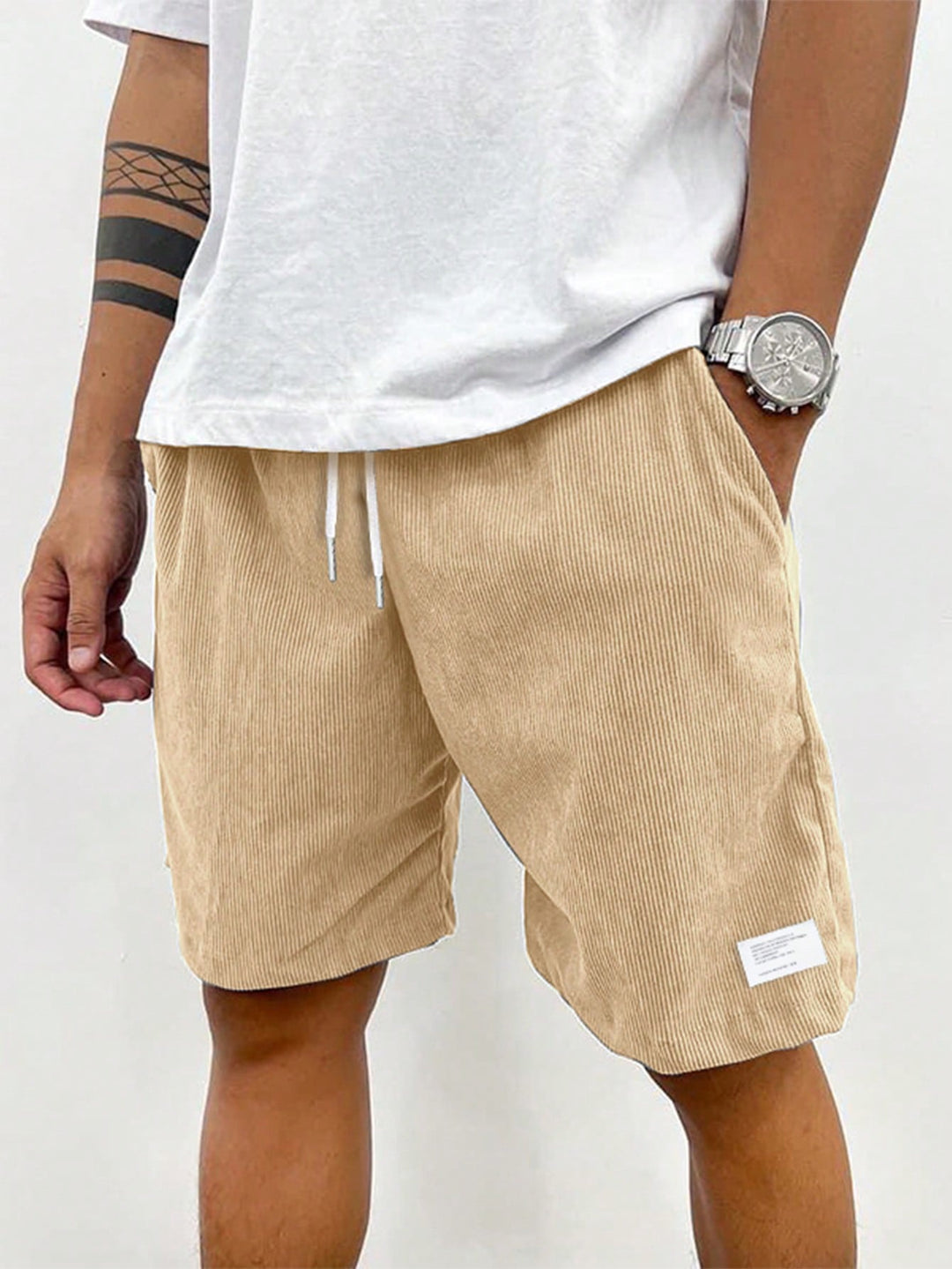 Model wearing grey men's relaxed fit casual drawstring shorts, showing comfortable fit.