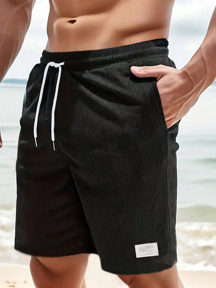 Pair of men's casual drawstring shorts in navy, a versatile addition to summer apparel.
