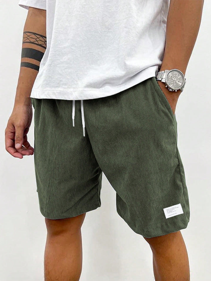 Relaxed fit men's shorts in olive green, featuring a practical drawstring closure.