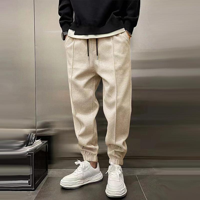 Men's relaxed fit casual trousers on a hanger, ready for wear, emphasizing easy-care and style
