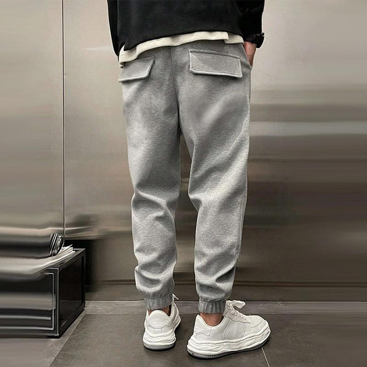 Close-up of fabric texture on men's relaxed fit casual trousers, showcasing comfort and quality