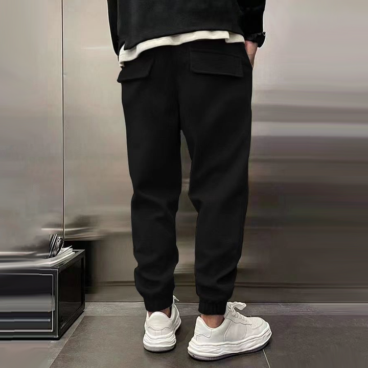 Back view of men's relaxed fit casual trousers with pockets, emphasizing comfortable design