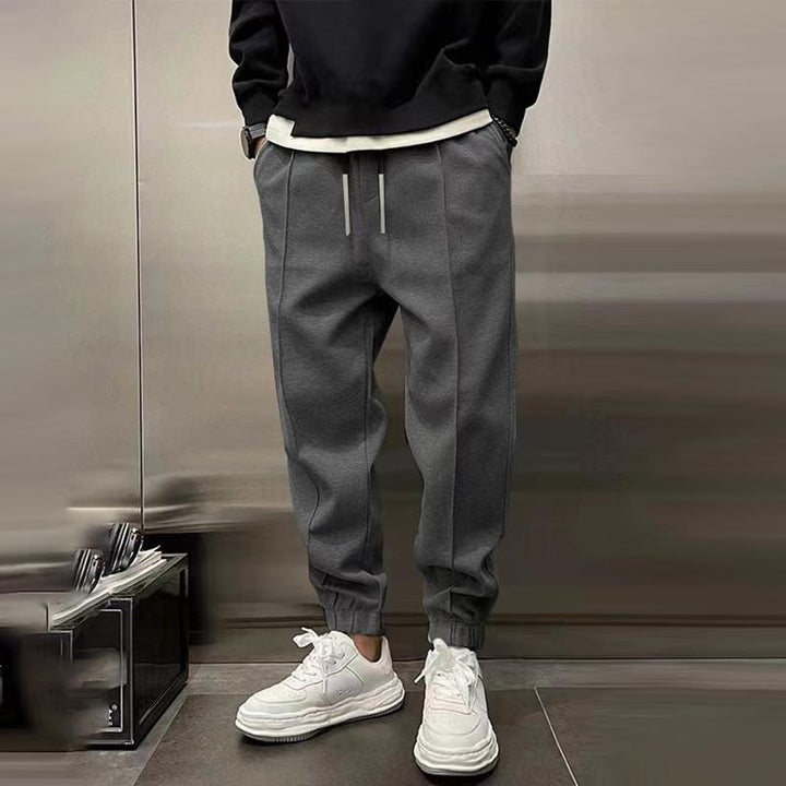 Detail shot of the waistband and drawstring on men's relaxed fit casual trousers for a perfect fit